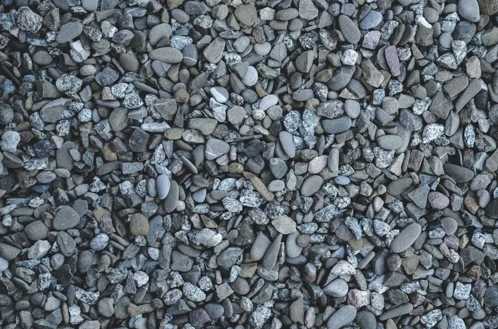 Close up of hands mixing soil and placing stones